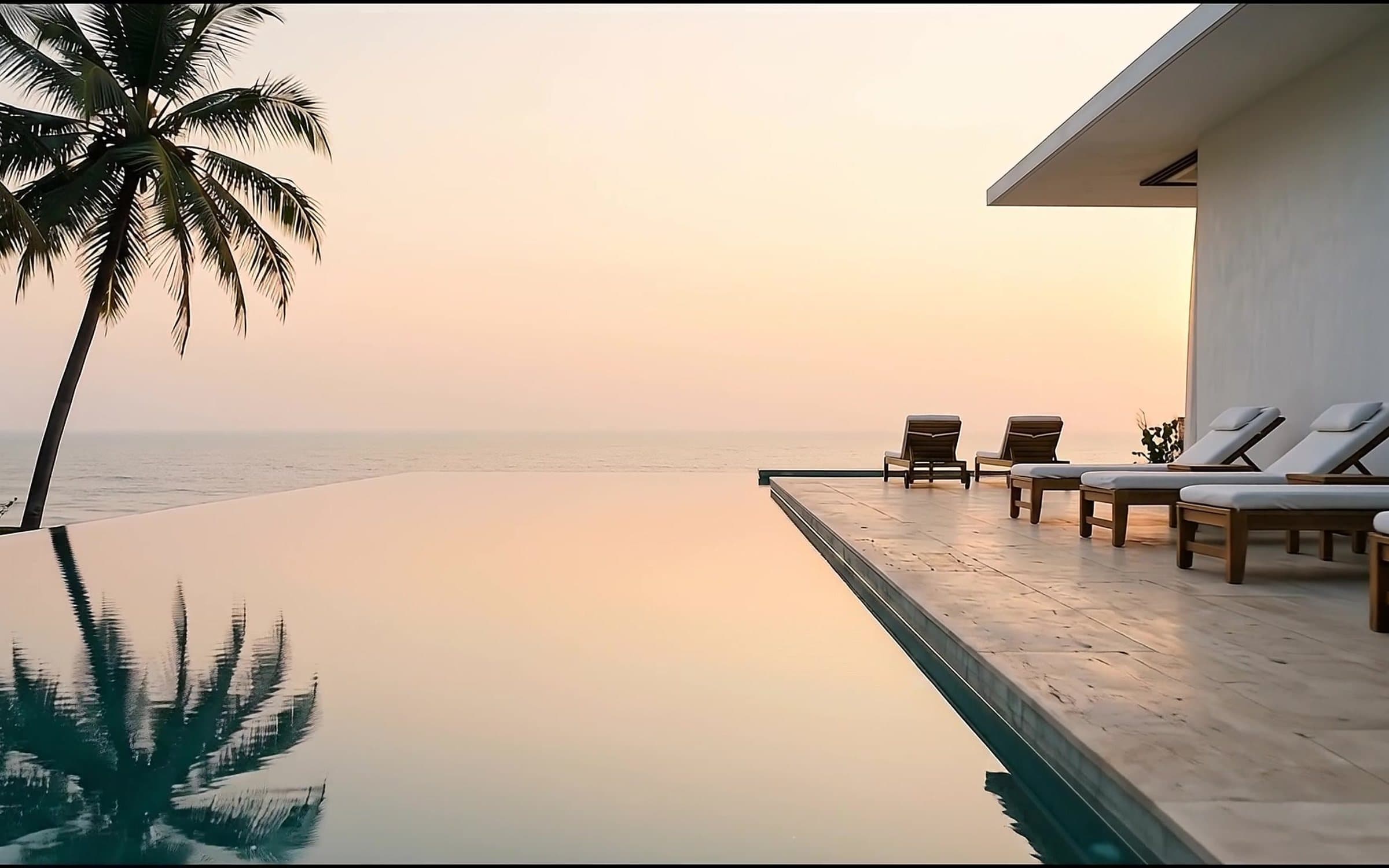 Palm reflections across the still infinity pool at sunset