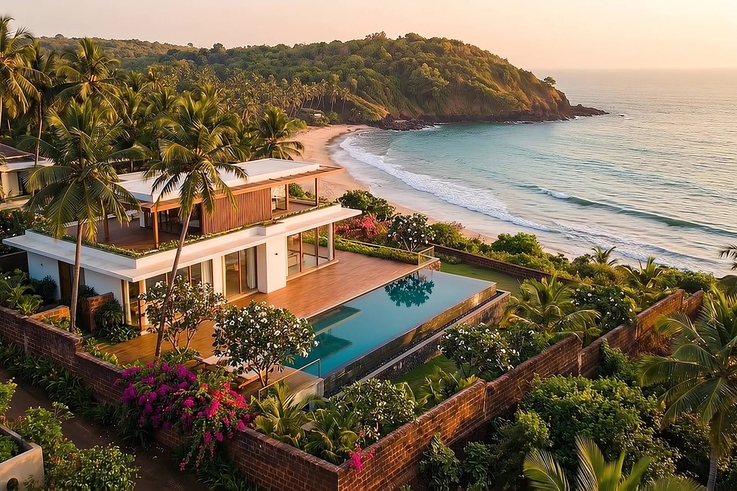 The villa and its pool from above, held in two acres of coastal garden